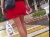 Middle aged woman in red short skirt and high heels