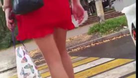 Middle aged woman in red short skirt and high heels