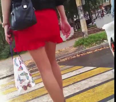Middle aged woman in red short skirt and high heels